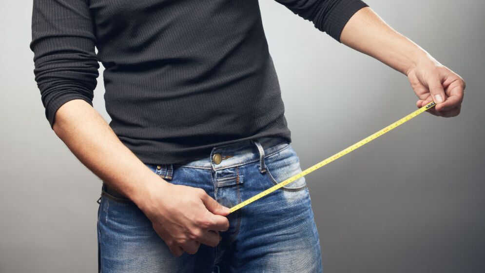 A man with a rule measures a member